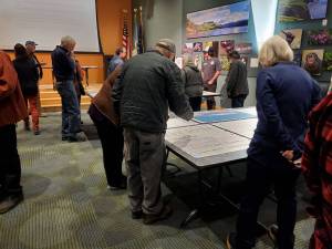 Attendees of the Comprehensive Plan Open House note where they want to see future growth in Homers economy on Thursday, March 28, 2024 at the Alaska Maritime National Wildlife Refuge Visitor Center auditorium in Homer, Alaska. (Delcenia Cosman/Homer News)