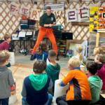 New and returning Homer OPUS students participate in a session of bucket drumming with Gretchen Grube, a visiting violinist, violin instructor and member of the Chicago-based band, The Gleasons, during a fall semester kickoff party at Little Fireweed Academy on Sunday, Aug. 18, 2024, in Homer, Alaska. Photo by Christina Whiting