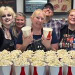 Homer Theatre staff Claire Peyton, Colleen Carroll, Piama Svoboda, Danny Rios, Jr. and Abi Rios pose with cups of the best hot, buttered popcorn in Alaska during the theaters Thanks for the Memories community party on Friday, Aug. 16, 2024, in Homer, Alaska. Photo by Christina Whiting
