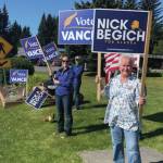 Homer residents hold political signs in support of Alaska House District 6 candidates at WKFL park in Homer on Aug. 20, 2024, in Homer, Alaska. (Emilie Springer/ Homer News)