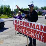 Sen. Jesse Bjorkman, R-Nikiski, and other supporters wave at passersby on the side of the Sterling Highway in Soldotna, Alaska, during the Alaska Primary Election Day on Tuesday, Aug. 20, 2024. (Jake Dye/Peninsula Clarion)