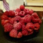 Raspberries fill a bucket on Saturday, Aug. 17, 2024, in Homer, Alaska. (Delcenia Cosman/Homer News)