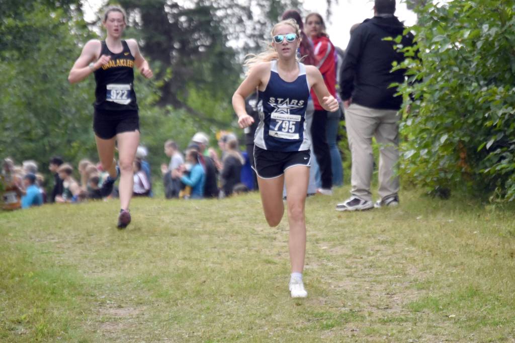 Soldotnas Kathryn DeBardelaben leads Unalakleets Ourea Busk at the Ted McKenney XC Invitational on Saturday, Aug. 24, 2024, at Tsalteshi Trails just outside of Soldotna, Alaska. (Photo by Jeff Helminiak/Peninsula Clarion)