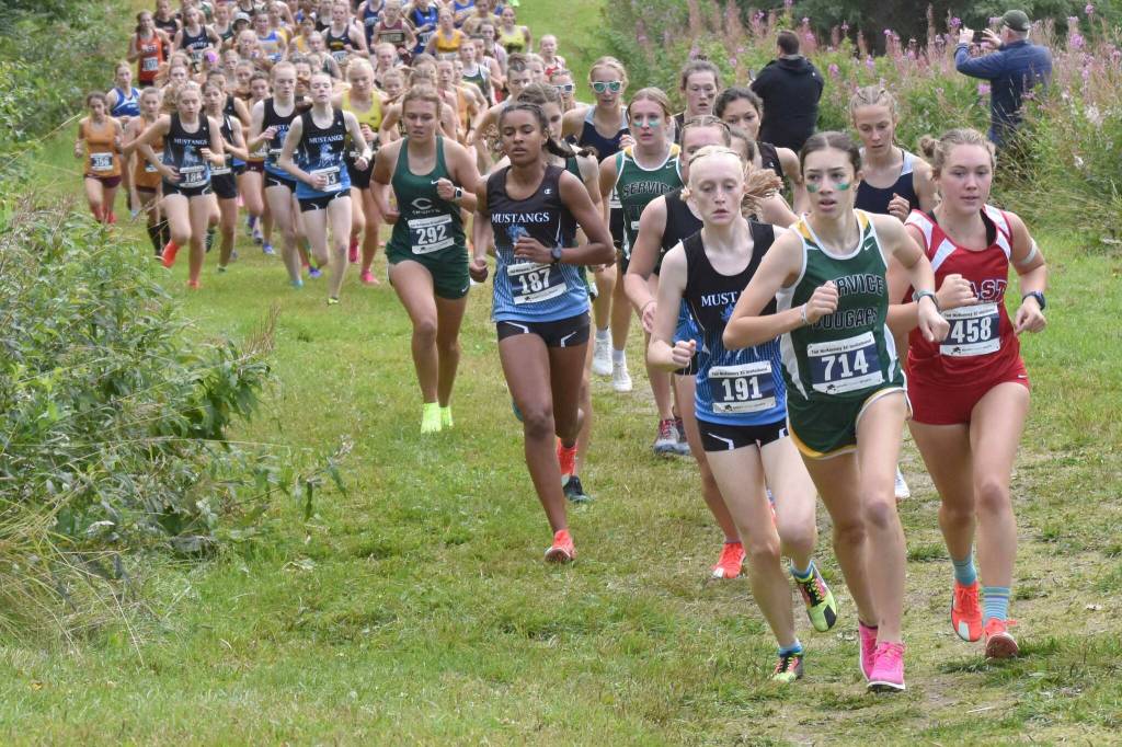 Service's Talia Smith leads the girls varsity race up Angle Hill during the Ted McKenney XC Invitational on Saturday, Aug. 24, 2024, at Tsalteshi Trails just outside of Soldotna, Alaska. (Photo by Jeff Helminiak/Peninsula Clarion)