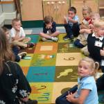 Kindergarteners give thumbs up to their teacher at Aurora Borealis Charter School in Kenai, Alaska, on the first day of the school year Wednesday, Aug. 21, 2024. (Jake Dye/Peninsula Clarion)
