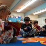 Students sit down to read books on the first day of the school year at Tustumena Elementary School in Kasilof, Alaska, on Wednesday, Aug. 21, 2024. (Jake Dye/Peninsula Clarion)