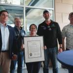 Kenai Peninsula College Director Cheryl Siemers, center, and University of Alaska Anchorage Chancellor Sean Parnell, center left, receive a legislative citation on behalf of KPC in recognition of the college's 60th anniversary presented by Rep. Justin Ruffridge, Sen. Jesse Bjorkman and Rep. Ben Carpenter during a celebration of that anniversary at Kenai Peninsula College in Soldotna, Alaska, on Tuesday, Aug. 20, 2024. (Jake Dye/Peninsula Clarion)