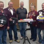 Left to right: Elks member Robert Lenny Euberts, Matthew Hockema, Homer High School band instructor Eric Simondsen, Lodge Exalted Ruler Jill Hockema and Heather Turner present instruments donated by Homer Elks Lodge #2127 to Homer High School on Aug. 30, 2024. (Emilie Springer/Homer News)