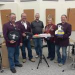 Left to right: Elks member Robert Lenny Euberts, Matthew Hockema, Homer High School band instructor Eric Simondsen, Lodge Exalted Ruler Jill Hockema and Heather Turner present instruments donated by Homer Elks Lodge #2127 to Homer High School on Friday, Aug. 30. (Emilie Springer/Homer News)