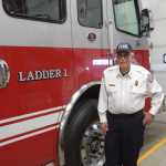 Retired fire chief Robert Cicciarella stands next to the Kachemak Emergency Services Ladder 1 truck on Thursday, Sept. 12, 2024, at KESA Station 1 in Homer, Alaska. (Delcenia Cosman/Homer News)