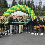 Center, from left: Kenai Peninsula Borough School District Superintendent Clayton Holland; Borough Mayor Peter Micciche; Seward High Student Council President Otto Nipp; and Seward High School Principal Dr. Henry Burns participate in a ribbon-cutting ceremony for a new turf field at Roger Steinbrecher Memorial Field at Seward High School, Friday, Sept. 13, 2024, in Seward, Alaska. (Photo by Jeff Helminiak/Peninsula Clarion)