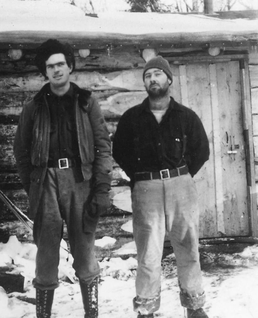 Wayne Jones (left) and William Bill Nutter, circa 1948-49, pose in front of the Happy Valley cabin that Nutter shared with his brother James. (Photo courtesy of Katie Matthews)