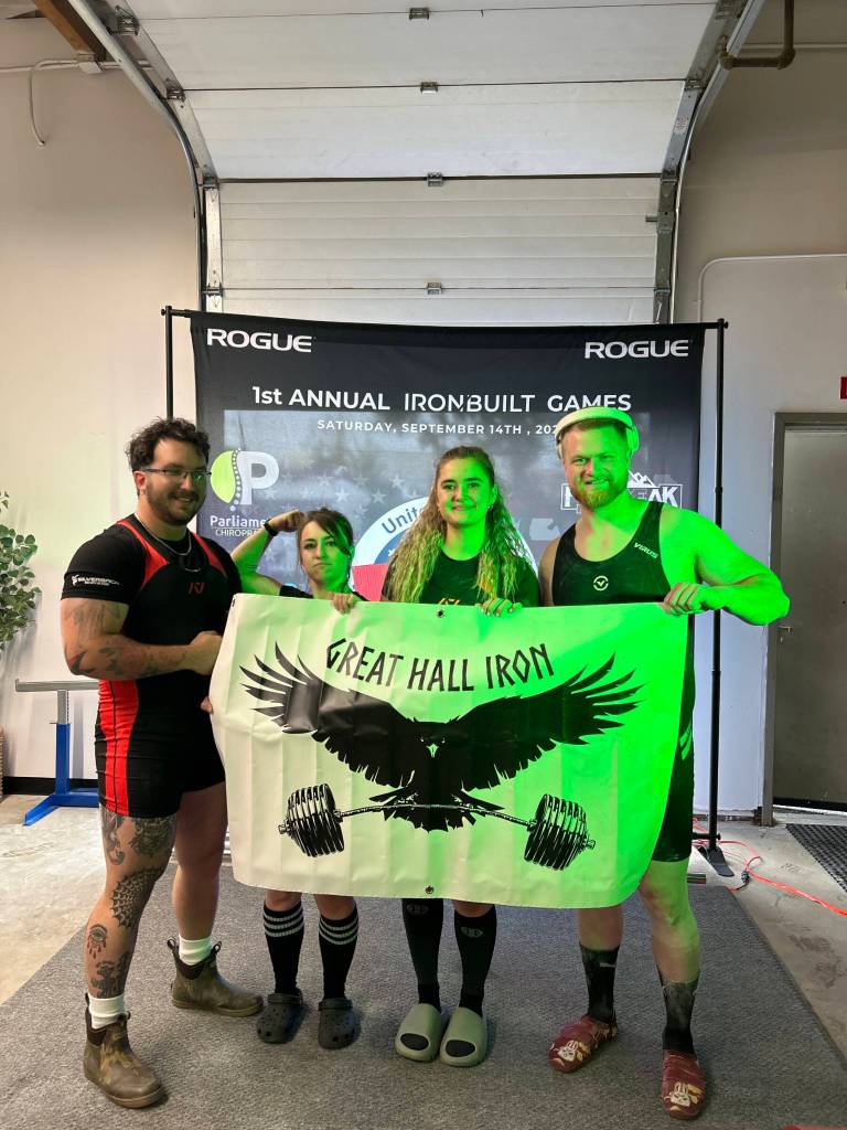 (from left to right) Tyler Warren, Chelsea Marsh, Annalynn Brown and Clayton Arndt pose with a Great Hall Iron banner at the first annual Rogue Iron Built Games on Saturday, Sept. 14, 2024, in Anchorage, Alaska. Photo provided by Annalynn Brown