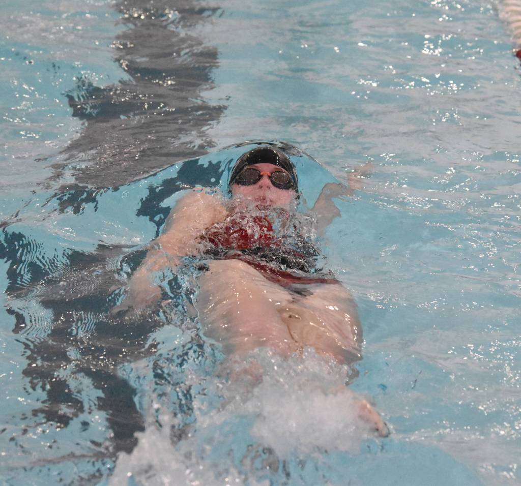 Kenai Centrals Lucy Anderson competes in the 100-yard backstroke at the Kenai Invitational on Saturday, Sept. 21, 2024, at Kenai Central High School in Kenai, Alaska. (Photo by Jeff Helminiak/Peninsula Clarion)