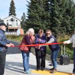 (from left to right) Homer mayor Ken Castner, city council members Shelly Erickson, Caroline Venuti and Rachel Lord, and city managers assistant Lori Pond conduct a ribbon cutting ceremony for the newly completed Ben Walters Lane Sidewalk Project on Monday, Sept. 30, 2024, at the corner of Ben Walters Lane and Smoky Bay Way in Homer, Alaska. (Delcenia Cosman/Homer News)