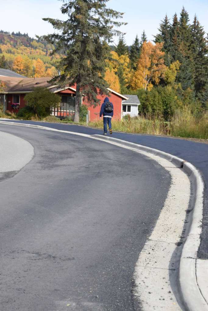 A local community member walks up Ben Walters Lane on the newly completed sidewalk on Monday, Sept. 30, 2024, in Homer, Alaska. (Delcenia Cosman/Homer News)