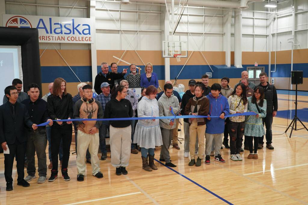 Alaska Christian College students, staff and other dignitaries gather as Styles Walker cuts the ribbon during a dedication ceremony for the colleges new athletic center at Alaska Christian College in Soldotna on Friday, Sept. 27. (Jake Dye/Peninsula Clarion)