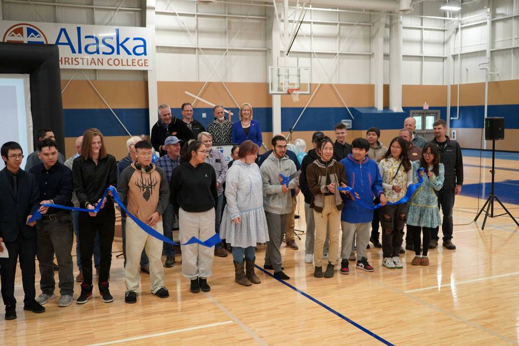 Alaska Christian College students, staff and other dignitaries gather as Styles Walker cuts the ribbon during a dedication ceremony for the colleges new athletic center at Alaska Christian College in Soldotna, Alaska, on Friday, Sept. 27, 2024. (Jake Dye/Peninsula Clarion)