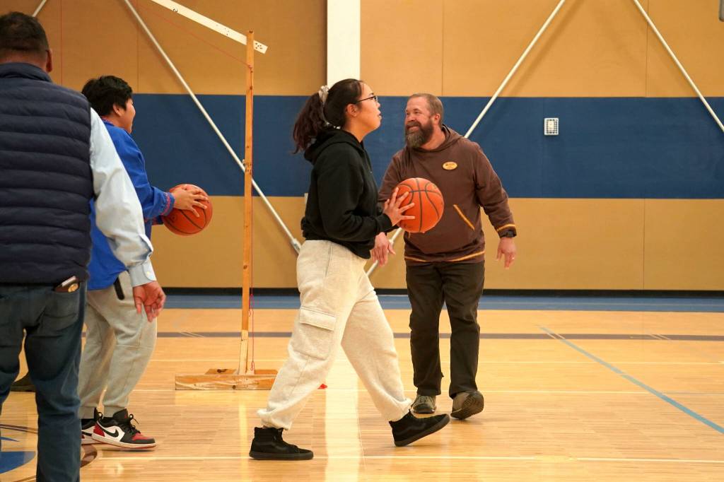 Alaska Christian College students and staff compete in a shot contest during a dedication ceremony for the colleges new athletic center at Alaska Christian College in Soldotna, Alaska, on Friday, Sept. 27, 2024. (Jake Dye/Peninsula Clarion)