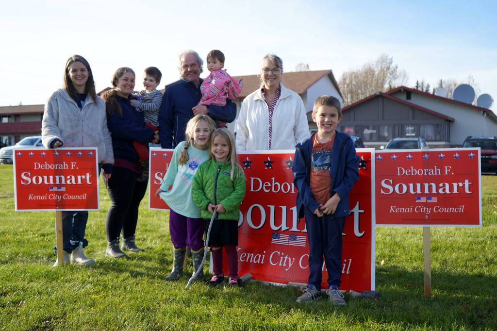 Deborah Sounart, alongside family and supporters, waves signs alongside the Kenai Spur Highway in Kenai, Alaska, on Tuesday, Oct. 1, 2024. (Jake Dye/Peninsula Clarion)