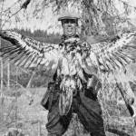 This photo of Warren Melville Nutter, holding a dead juvenile bald eagle that he shot for the bounty, appeared in the May 1938 edition of The Alaska Sportsman Magazine. The photo was probably taken near the mouth of Hidden Creek on Skilak Lake.