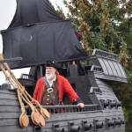 Owner and vendor Kevin Hall stands aboard his pirate ship, visiting from the Anchorage Pirate Festival, at Ye Olde Harvest Festival at Karen Hornaday Park on Saturday, Oct. 5, 2024, in Homer, Alaska. (Delcenia Cosman/Homer News)