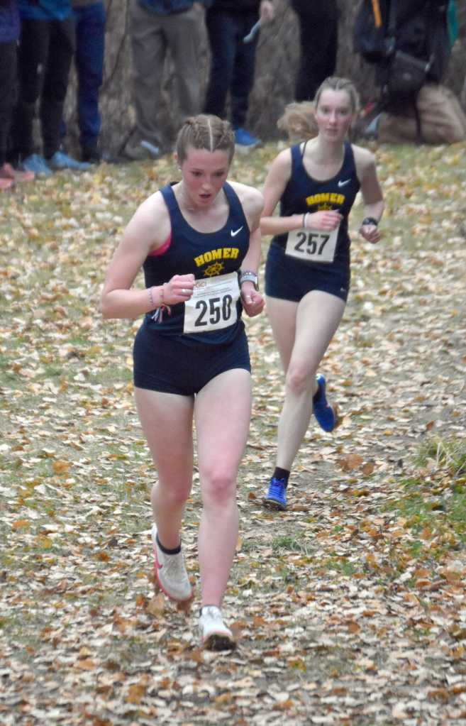 Homers Claira Booz leads Beatrix McDonough in the Division II girls race at the state cross-country running meet on Saturday, Oct. 5, 2024, at Bartlett High School in Anchorage, Alaska. (Photo by Jeff Helminiak/Peninsula Clarion)