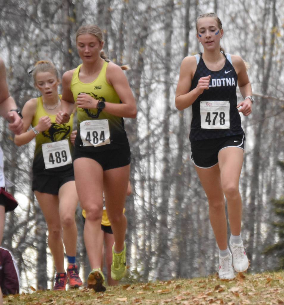 Soldotnas Kathryn DeBardelaben runs alongside Souths Addysen Gasser in the Division I girls race at the state cross-country running meet on Saturday, Oct. 5, 2024, at Bartlett High School in Anchorage, Alaska. (Photo by Jeff Helminiak/Peninsula Clarion)