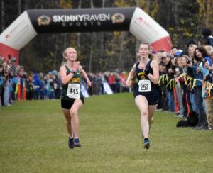Sewards Juniper Ingalls and Homers Beatrix McDonough sprint to the finish in the Division II girls race at the state cross-country running meet on Saturday, Oct. 5, 2024, at Bartlett High School in Anchorage, Alaska. (Photo by Jeff Helminiak/Peninsula Clarion)