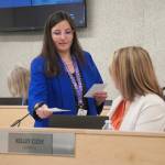Administrative Secretary Nikkol Sipes passes out ballots during a reorganization of the Kenai Peninsula Borough School District Board of Education in Soldotna, Alaska, on Monday, Oct. 14, 2024. (Jake Dye/Peninsula Clarion)