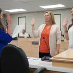 Administrative Secretary Nikkol Sipes administers oaths of office to Kenai Peninsula Borough School District Board of Education members Kelley Cizek and Sarah Douthit on Monday, Oct. 14, 2024. Cizek was reelected to represent Sterling and Funny River, Douthit was elected to represent Kenai during the Oct. 1 municipal election. (Jake Dye/Peninsula Clarion)
