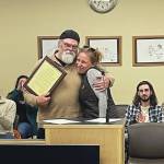 Homers new mayor, Rachel Lord, presents outgoing Mayor Ken Castner with a plaque recognizing his service to the City of Homer at the conclusion of the city council meeting at the Cowles Council Chambers at Homer City Hall on Oct. 14, 2024, in Homer, Alaska. (Emilie Springer/Homer News)
