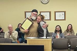 Homers new mayor, Rachel Lord, presents outgoing Mayor Ken Castner with a plaque recognizing his service to the City of Homer at the conclusion of the city council meeting at the Cowles Council Chambers at Homer City Hall on Oct. 14, 2024, in Homer, Alaska. (Emilie Springer/Homer News)