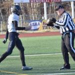 Homers CJ Burns hands the ball to the official after scoring the first touchdown of the game Saturday, Oct. 19, 2024, in the Division III First National Bowl at Veterans Memorial Field at Wasilla High School in Wasilla, Alaska. (Photo by Jeff Helminiak/Peninsula Clarion)