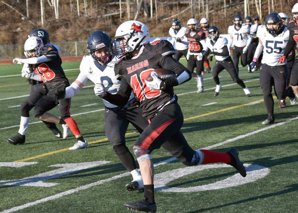 Kenai Centrals Bobby Hayes runs against Homers Nikifor Reutov on Saturday, Oct. 19, 2024, in the Division III First National Bowl at Veterans Memorial Field at Wasilla High School in Wasilla, Alaska. (Photo by Jeff Helminiak/Peninsula Clarion)