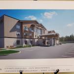 A schematic rendering of the hotel main entrance in Doyon, Limiteds revised Lighthouse Village redevelopment design is on display during a special Planning Commission meeting on Wednesday, Oct. 16, 2024, in the Homer City Hall Cowles Council Chambers in Homer, Alaska. (Delcenia Cosman/Homer News)