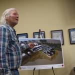 Don McNamara points to a schematic of the proposed Lighthouse Village hotel development while giving public comments to the Planning Commission on Doyon, Limiteds revised application during a special meeting on Wednesday, Oct. 16, 2024, in Homer, Alaska. (Delcenia Cosman/Homer News)