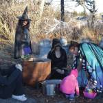Community members collect candy from a witchs cauldron in the Haunted Trail during the third annual Fall Fest on Saturday, Oct. 26<ins>, 2024,</ins> at the Homer Chamber of Commerce and Visitor Center<ins> in Homer, Alaska</ins>. (Delcenia Cosman/Homer News)