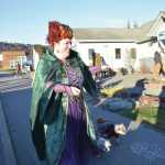 Ashley Vecellio, costumed with her dogs Daisy and Bella as the Sanderson sisters from the 1993 Disney film Hocus Pocus, walk down the runway for the Pet Costume Contest during the third annual Fall Fest on Saturday, Oct. 26<ins>, 2024,</ins> at the Homer Chamber of Commerce and Visitor Center<ins> in Homer, Alaska</ins>. (Delcenia Cosman/Homer News)