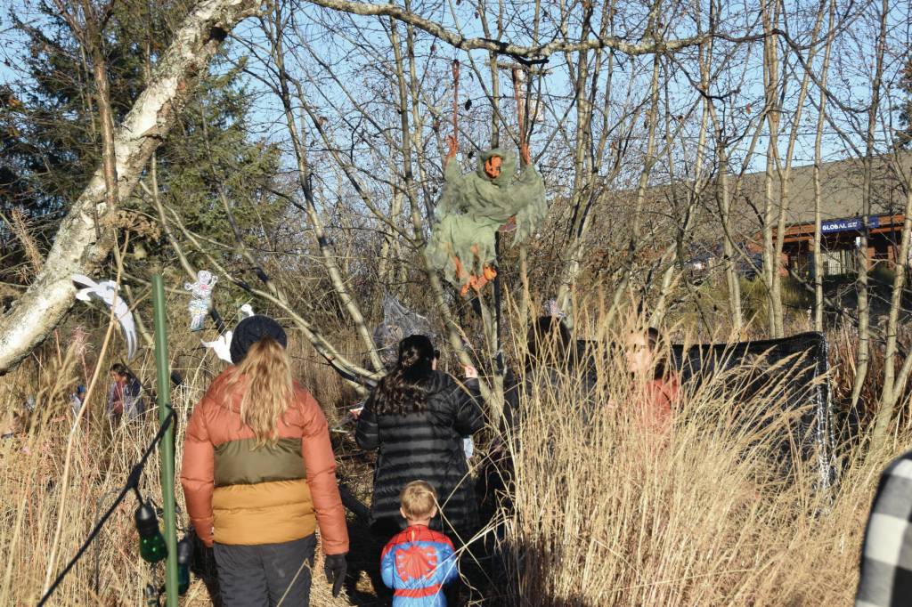 Community members attending Homer Chamber of Commerces third annual Fall Fest walk through the Haunted Trail on Saturday, Oct. 26<ins>, 2024, at the Homer Chamber of Commerce and Visitor Center in Homer, Alaska</ins>. (Delcenia Cosman/Homer News)