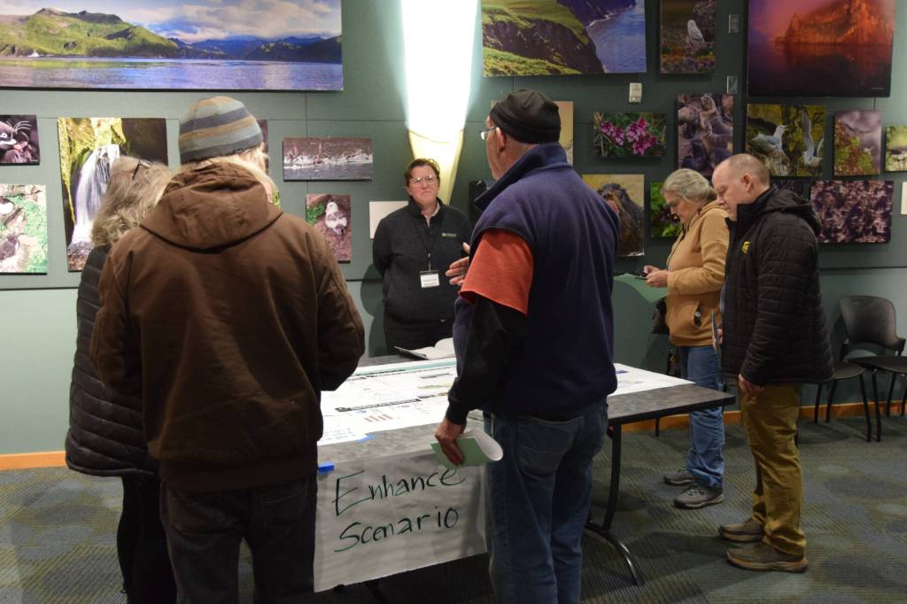 Community members review and discuss the Enhance growth scenario with each other and with comprehensive plan rewrite project team members during a community work session on Tuesday, Oct. 22, 2024, at the Alaska Maritime National Wildlife Refuge Visitor Center in Homer, Alaska. (Delcenia Cosman/Homer News)