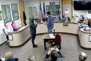 Seward City Clerk Kris Peck, right, administers an oath of office to Seward City Council newcomer Casie Warner during a council meeting in Seward, Alaska, on Oct. 28, 2024. (Screenshot courtesy City of Seward)