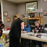 Poll workers sign in voters and hand out ballots at the Anchor Point Community and Senior Center, the polling location for the Anchor Point precinct, on Tuesday, Nov. 5<ins>, 2024, in Anchor Point, Alaska</ins>. (Delcenia Cosman/Homer News)