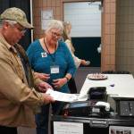 Poll worker Carol Louthan helps voters submit ballots at the Soldotna Regional Sports Complex in Soldotna, Alaska, on Tuesday, Nov. 5, 2024. (Jake Dye/Peninsula Clarion)