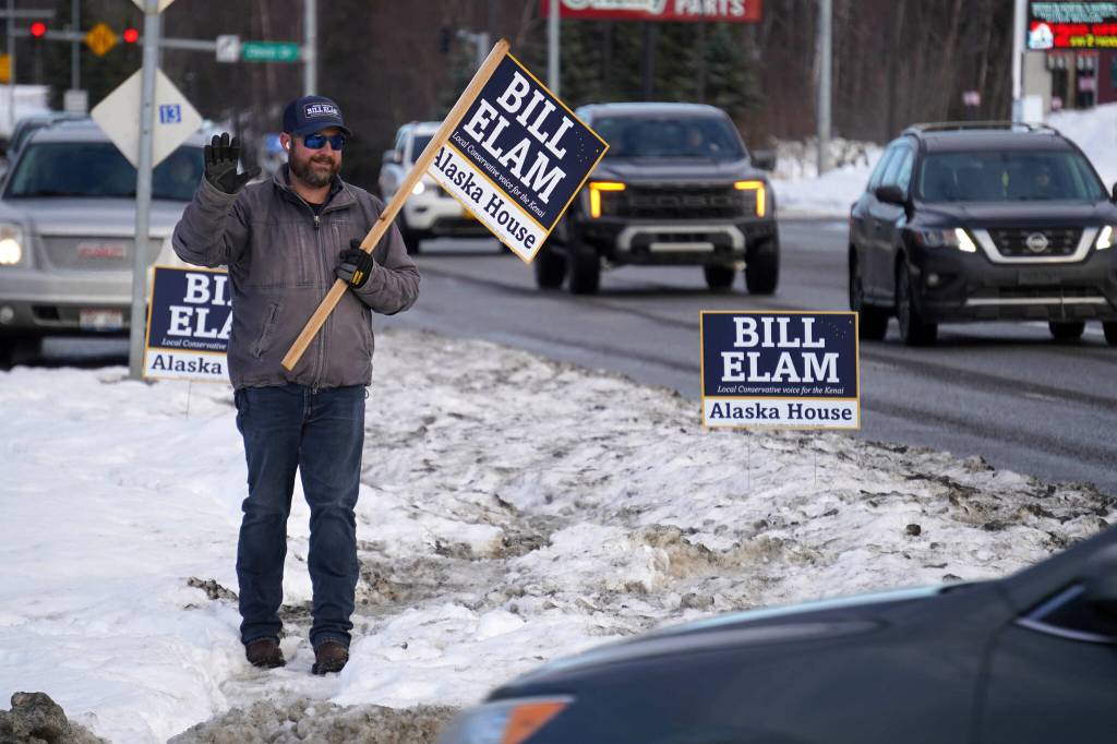 Bill Elam waves at passersby along the Sterling Highway in Soldotna, Alaska, on Tuesday, Nov. 5, 2024. (Jake Dye/Peninsula Clarion)
