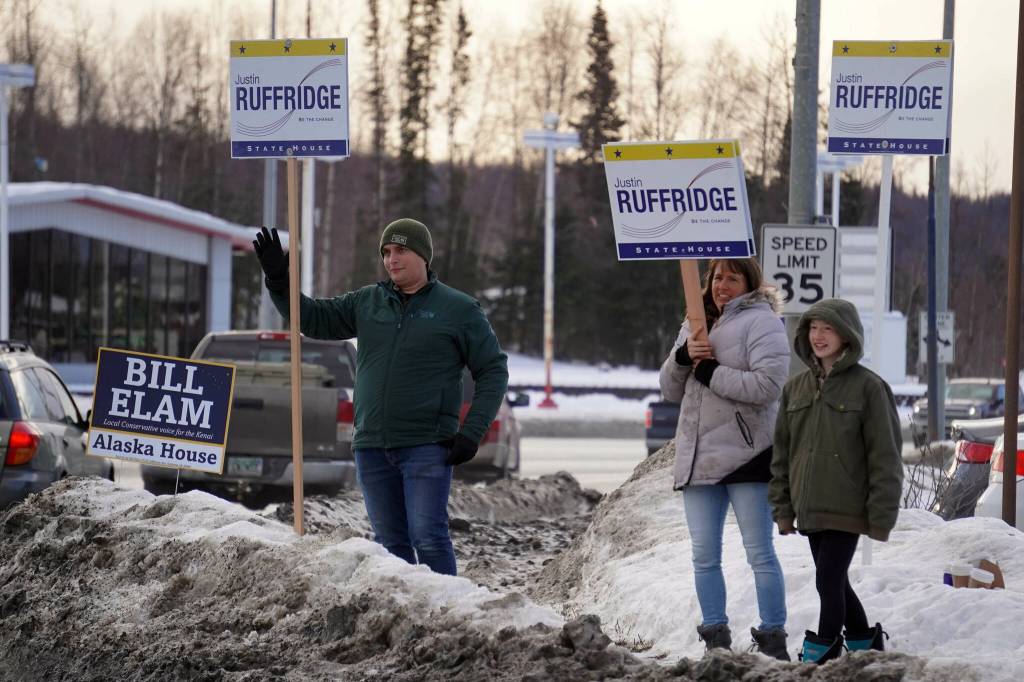 Justin Ruffridge and other supporters wave at passersby along the Sterling Highway in Soldotna, Alaska, on Tuesday, Nov. 5, 2024. (Jake Dye/Peninsula Clarion)