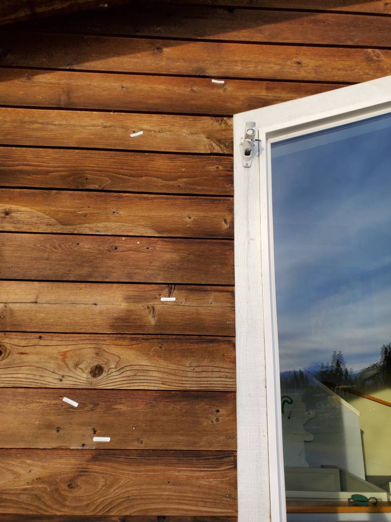 Multiple bullet holes in the front exterior of the Kachemak Bay Family Planning Clinics administrative and education building are marked on Tuesday, Nov. 12, 2024, following a shooting incident that occurred on Monday, Nov. 11 in Homer, Alaska. (Delcenia Cosman/Homer News)