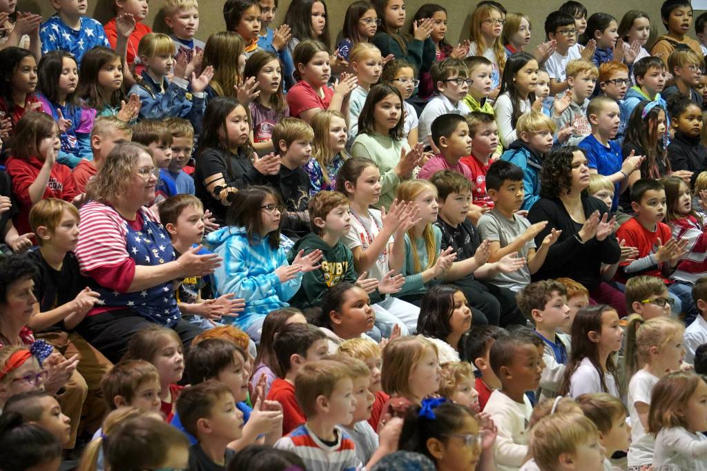 Students applaud as veterans are introduced at Mountain View Elementary in Kenai, Alaska, during a celebration of Veterans Day on Monday, Nov. 11, 2024. (Jake Dye/Peninsula Clarion)