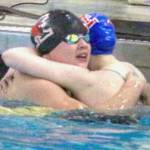 Kenai’s Abigail Price hugs Taryn Fleming from Sitka during the state swimming and diving championships Saturday, Nov. 9, 2024, at Bartlett High School in Anchorage, Alaska. (Photo by Kyle Wilkinson/For the Frontiersman)