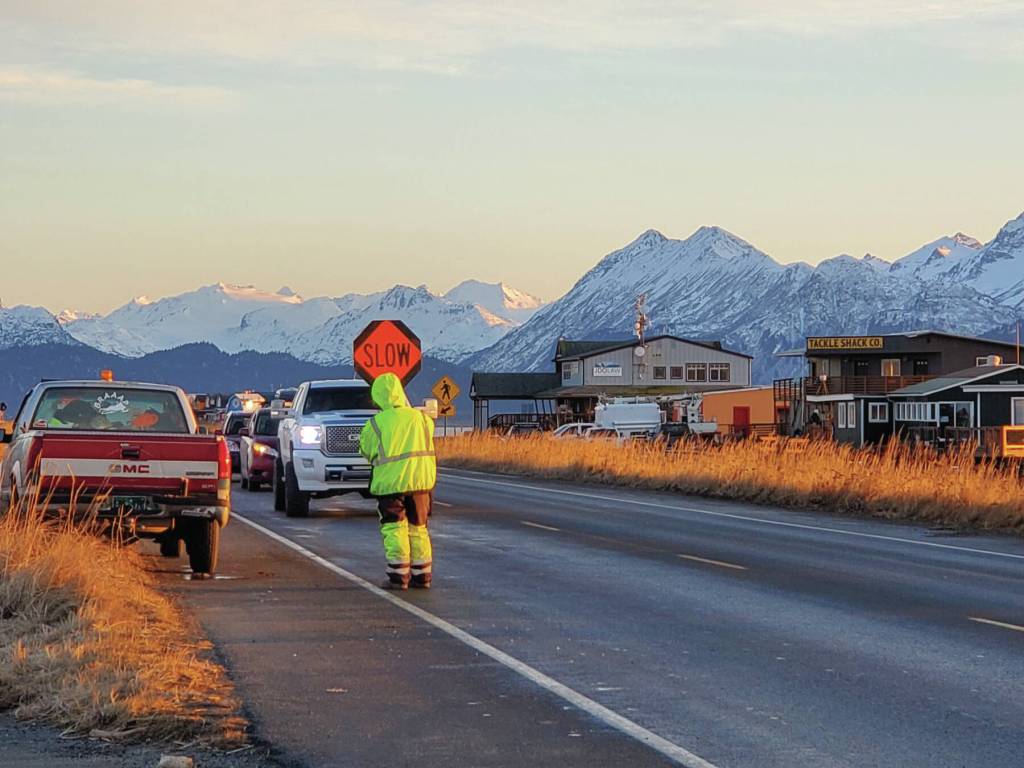 A flagger conducts a traffic stop on Homer Spit Road on Thursday, Nov. 21<ins>, 2024, in Homer, Alaska</ins>. (Delcenia Cosman/Homer News)